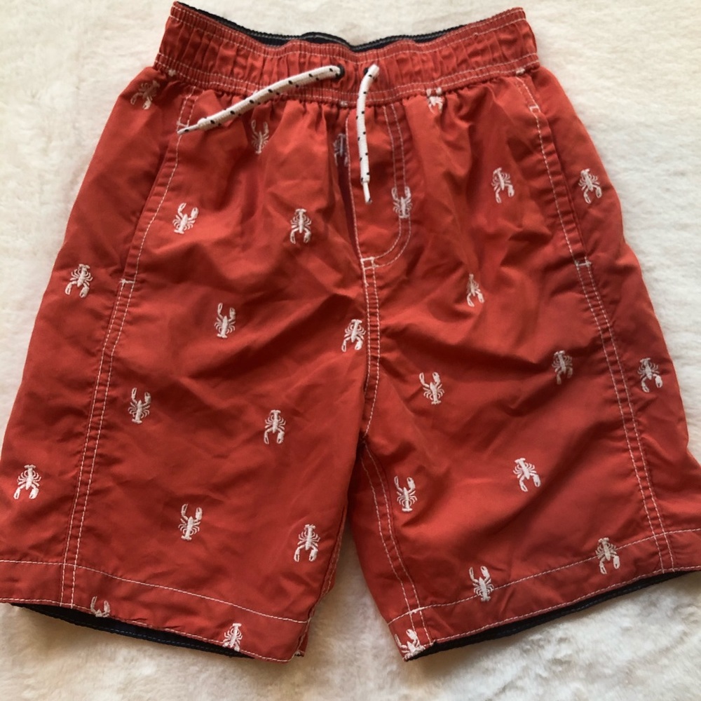 Carter’s size 7 lobster swim trunks